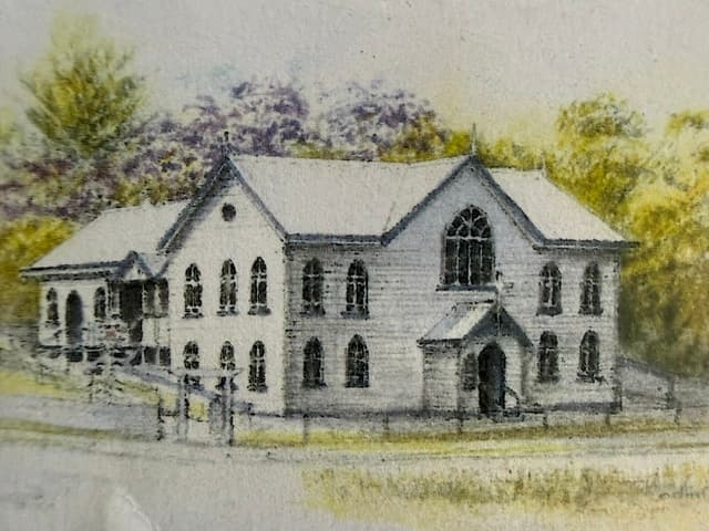 A watercolour painting of the heritage Bulimba Uniting Church building — white weatherboard with arched gothic windows, a steep gable roof, and a small entry porch, set among gum trees with a low picket fence at the road.